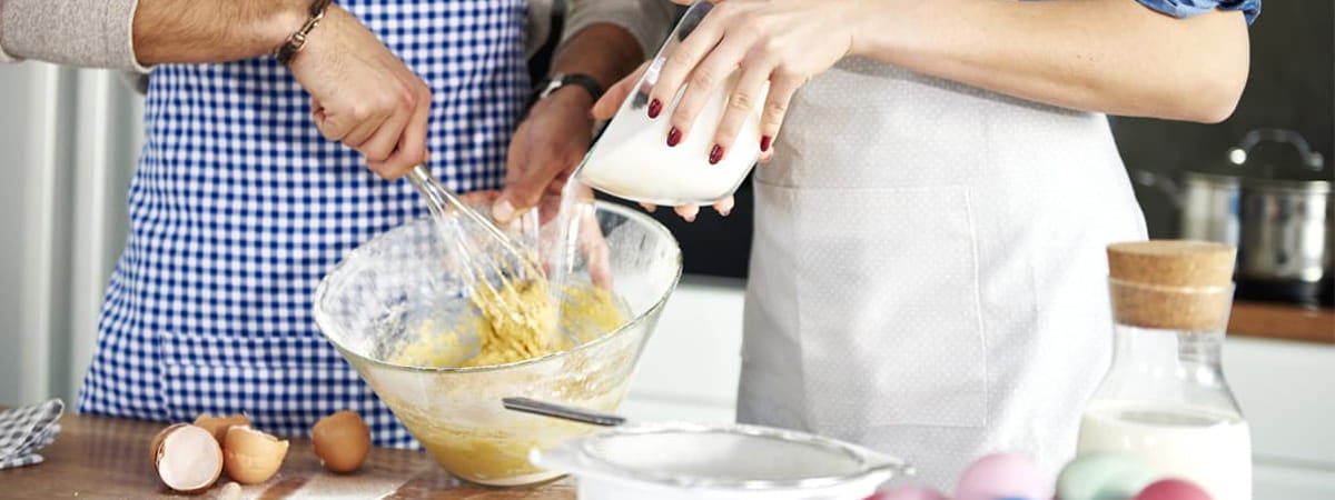 Sobremesa de páscoa: Um homem à esquerda e uma mulher à direita, ambos cozinhando