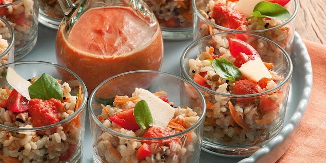 Copinhos de vidro com salada de arroz com tomate, queijo e manjericão.
