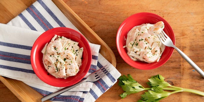 Dois bowls vermelhos com salada de camarão cremoso.
