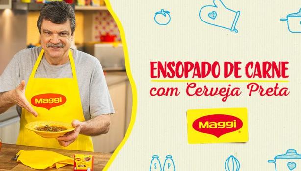 Imagem de um homem alto com bigode de avental segurando um prato amarelo e ao lado direito os dizeres e o logotipo de Maggi