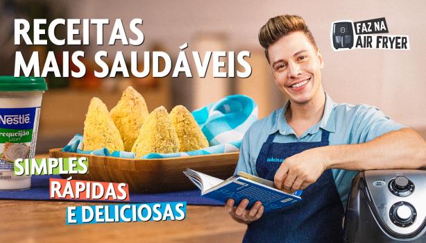 Fotografia mostra um rapaz segurando um livro e coxinhas ao lado.