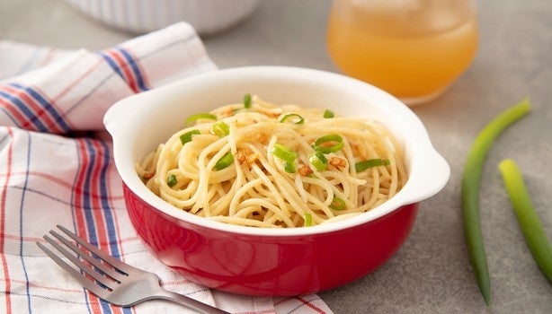 Imagem de um bowl vermelho com macarrão alho e óleo.