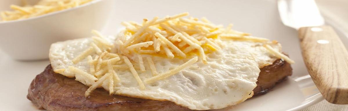 Filé à Cavalo Maggi em um prato com faca