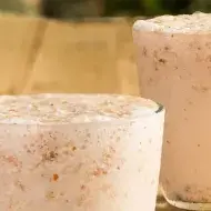 Frappé de Amêndoas com Coco em cima de uma mesa de madeira
