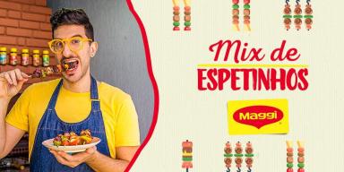 Lucas está comendo, vestindo uma camiseta amarela e um avental jeans. Também está escrito mix de Espetinhos e o logo de Maggi