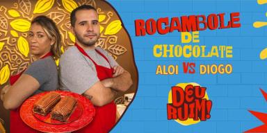 Imagem escrito Rocambole e Aloi vs Diogo seguido pelo logo Deu Ruim. À esquerda, fotos dos participantes e do rocambole.