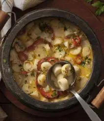 Imagem de uma panela rústica com moqueca de palmito