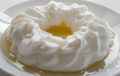 Em cima de uma mesa, prato com beijo gelado branco de coco.