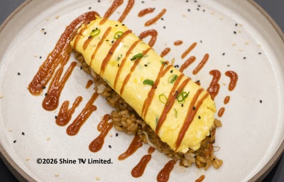 Foto profissional da Receita de Omurice com Arroz Frito e Omelete Cremosa em um prato redondo, decorado com um molho