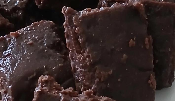 Fotografia de vários pedaços de um doce de corte com açaí, um sobre o outro.