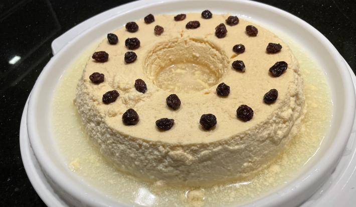 Imagem da receita de Pudim de Kefir, em um recipiente branco sobre uma mesa