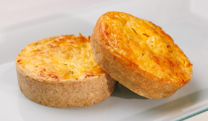 Fotografia de dois salgados assados feitos com massa podre e recheio cremoso de Requeijão NESTLÉ, champignon e cebolinha.