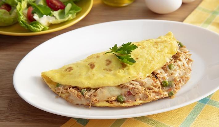 Foto da Receita de Omelete com Sobras de Frango. Observa-se uma omelete recheada com frango em um prato branco.