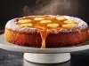 Bolo de banana coberto com fatias de banana e calda de caramelo escorrendo pelas laterais. O bolo está sobre um prato de bolo branco, e há açúcar de confeiteiro polvilhado nas bordas. O vapor saindo do topo mostra que o bolo está quentinho.