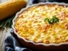 Em cima de uma mesa, recipiente de porcelana redondo com queijo gratinado.