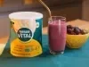 imagem mostra um copo de refresco vermelho cremoso preparado com morangos, amoras e mirtilos