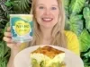 Fotografia em tons de verde com uma moça segurando um prato. No prato existe uma receita de torta de brócolis saudável feita com NINHO Adulto